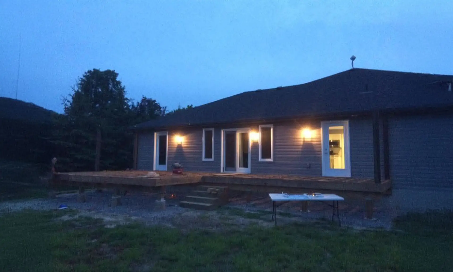 Residential exterior upgrade with newly constructed deck during early installation stage