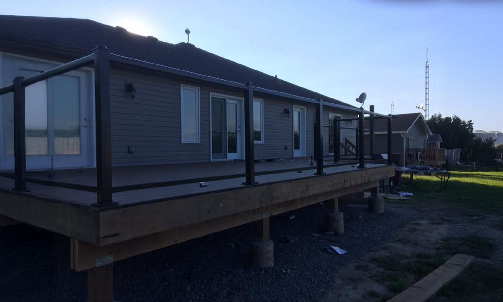 Residential exterior upgrade with elevated deck and railing installation