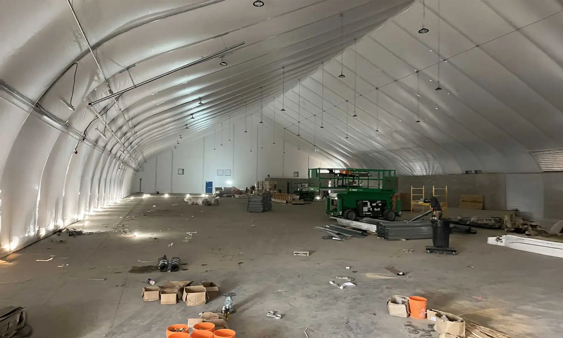 Interior construction of municipal community arena with arched roof structure